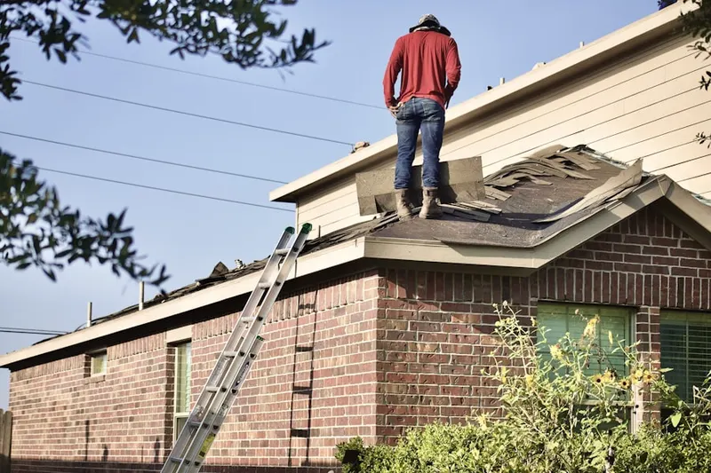 Professional roofer working on a residential roof in Meadows Park